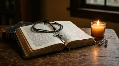 An open King James Bible and a lit candle in warm golden light, hands resting in prayer