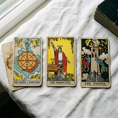 The 1971 Rider-Waite tarot deck on white linen · Wheel of Fortune, Magician, Tower laid face-up